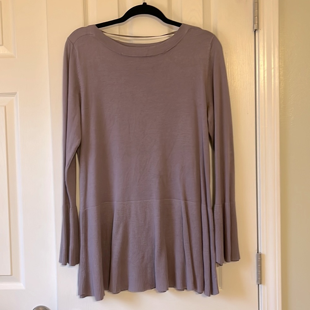 This is a light weight, light purple, tunic sweater by cable and gauge.